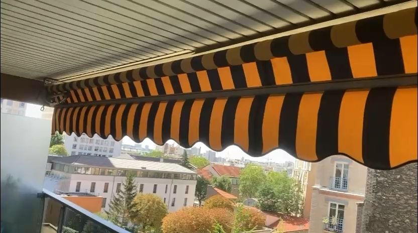 Store banne de balcon avec toile rayée neuve tendue sur les bras existants – store banne à Issou