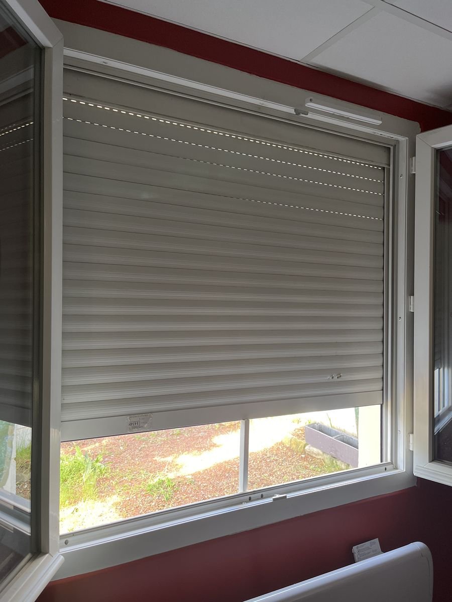 New white roller shutter seen from inside, curtain lowered – roller shutter repair in Forges-les-Bains